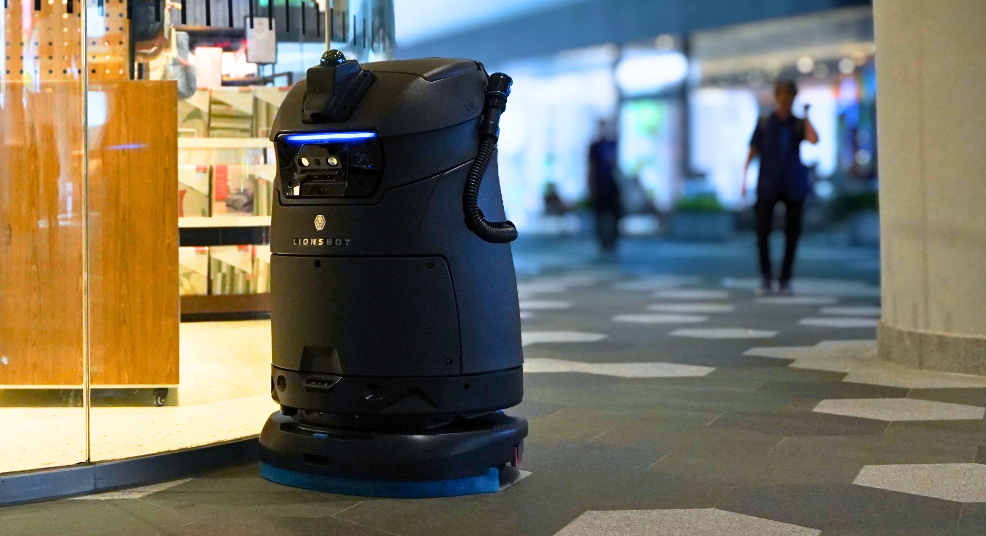 Deployed Lionsbot cleaning robot operating in a commercial space